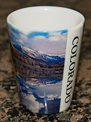 Shot glass with photos of the Rocky Mountains.